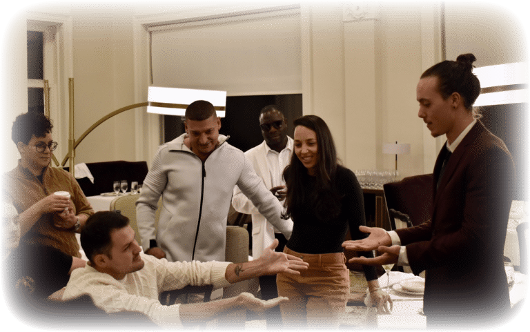 Eaden Marti performing a coin trick in front of a small crowd.